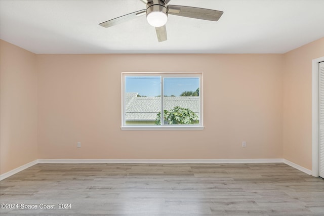 spare room with ceiling fan and light wood-type flooring