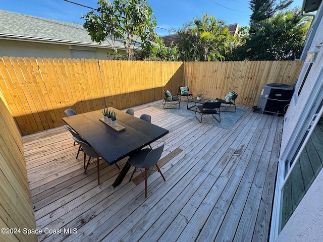 wooden terrace featuring central AC unit