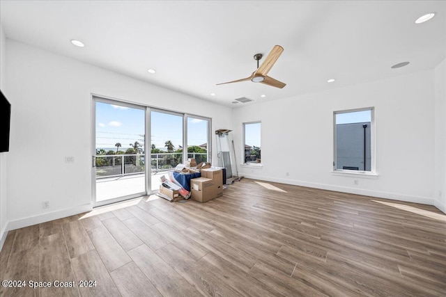 unfurnished living room featuring hardwood / wood-style floors and ceiling fan