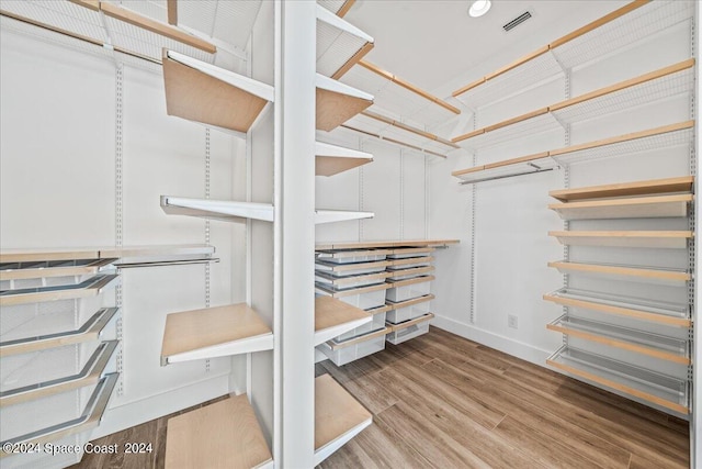 walk in closet with wood-type flooring