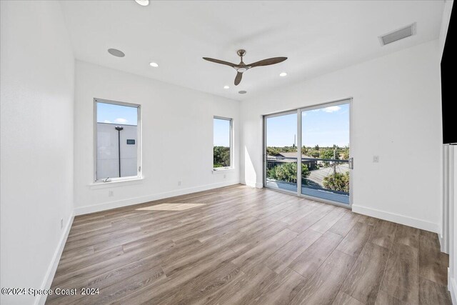 unfurnished room with ceiling fan and light hardwood / wood-style flooring