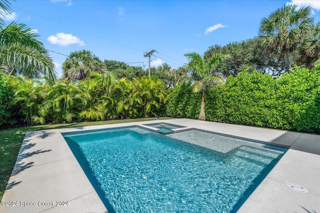 view of pool with an in ground hot tub