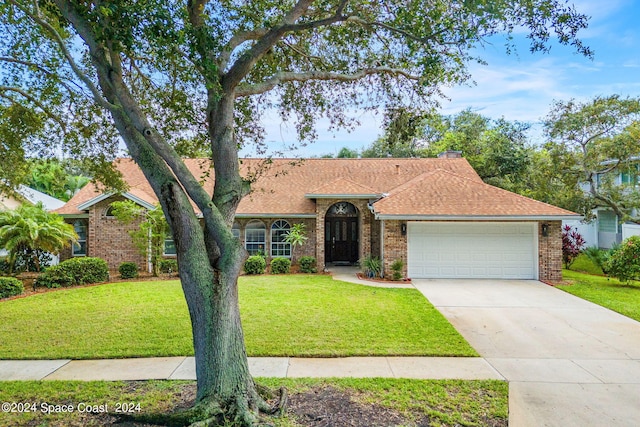 ranch-style home featuring a front yard and a garage