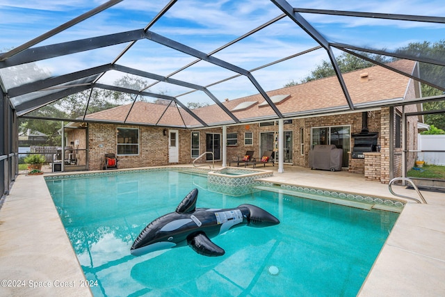 view of swimming pool with a patio, an in ground hot tub, and a lanai