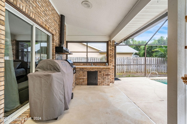 view of patio / terrace featuring sink and glass enclosure