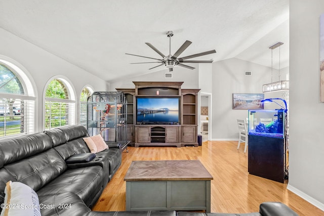 living room featuring ceiling fan, hardwood / wood-style floors, and vaulted ceiling