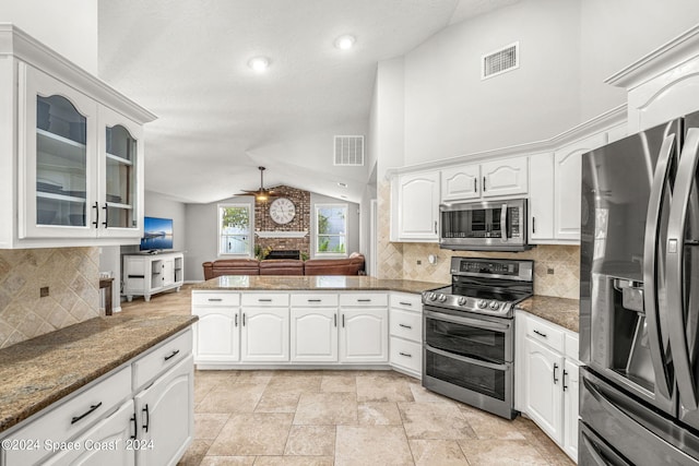 kitchen with ceiling fan, appliances with stainless steel finishes, lofted ceiling, and white cabinetry