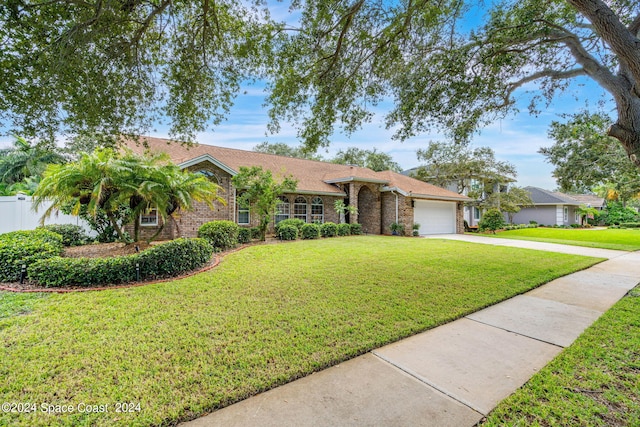 single story home with a front yard and a garage