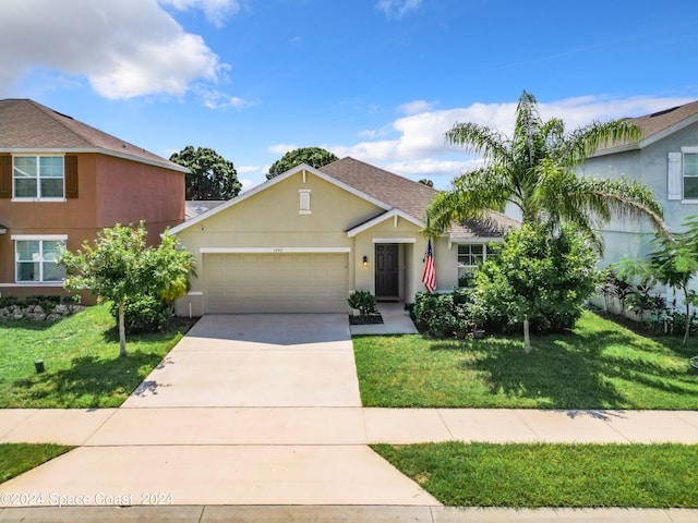 view of front of house featuring a front yard and a garage