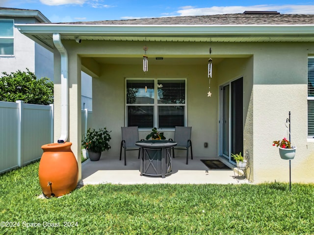 rear view of house featuring a yard and a patio