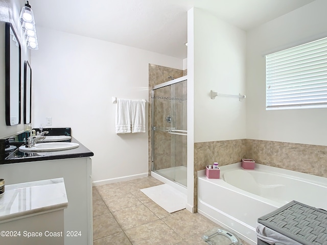 bathroom with shower with separate bathtub, vanity, and tile patterned floors