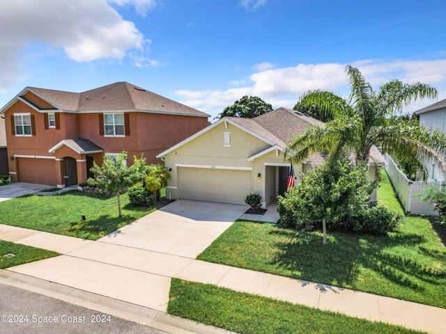 view of front of home featuring a front lawn and a garage