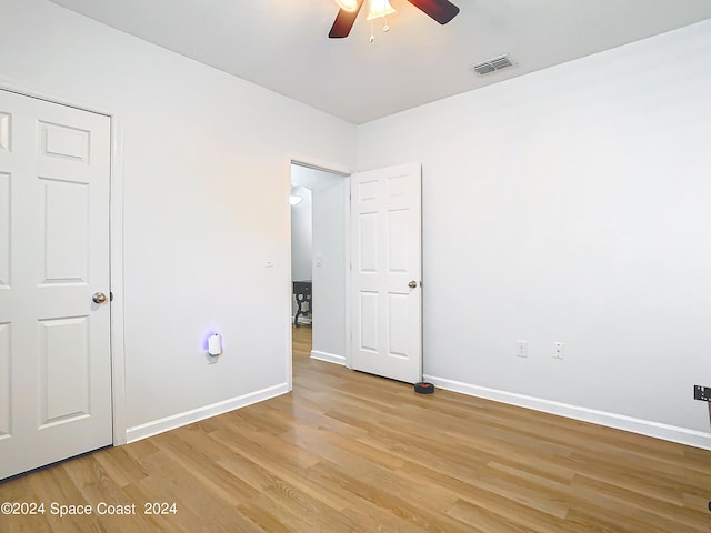 unfurnished bedroom with ceiling fan and light hardwood / wood-style flooring