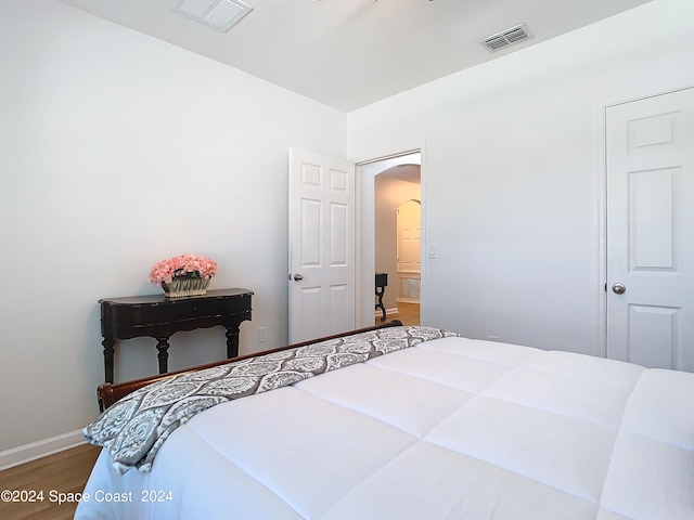 bedroom with wood-type flooring