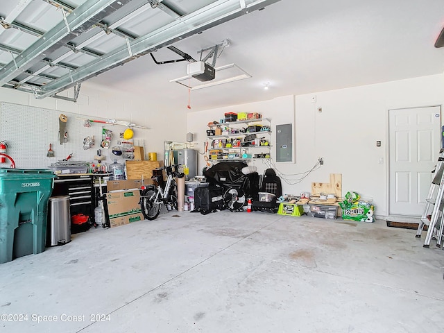 garage featuring electric panel, a garage door opener, and a workshop area