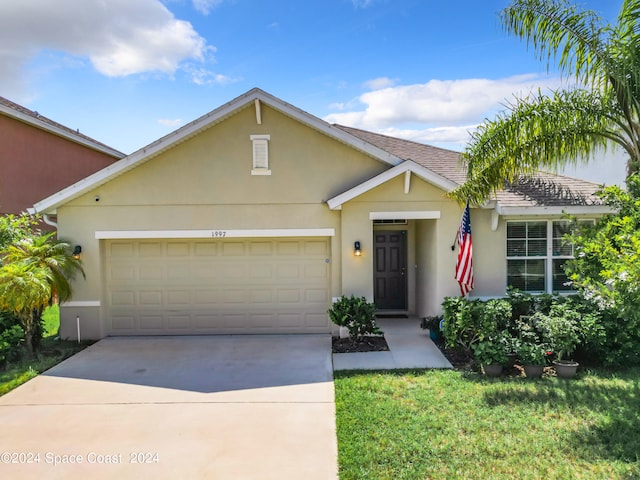 ranch-style home with a front lawn and a garage