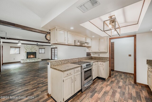 kitchen with dark wood-type flooring, extractor fan, a stone fireplace, light stone countertops, and stainless steel range with electric cooktop