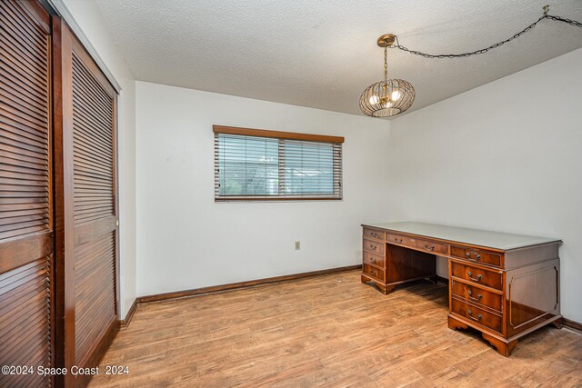 office area featuring light hardwood / wood-style flooring and a textured ceiling