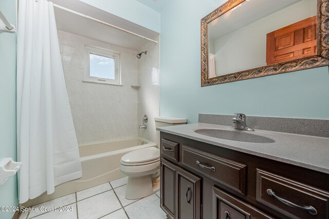 full bathroom with tile patterned flooring, vanity, toilet, and shower / bath combo with shower curtain