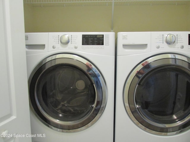 washroom with washer and dryer