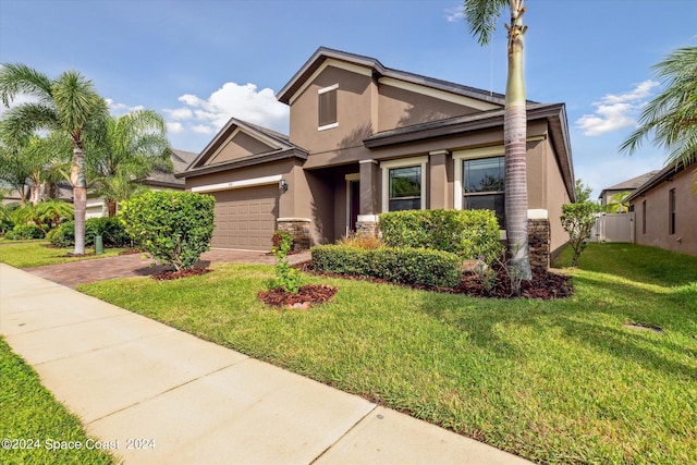 view of front of house with a garage and a front lawn