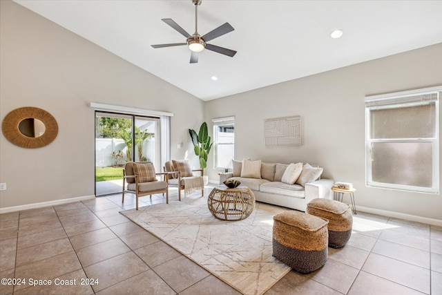 living room featuring ceiling fan, light tile patterned floors, and high vaulted ceiling