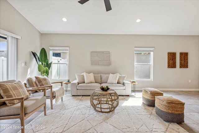 tiled living room with ceiling fan and plenty of natural light