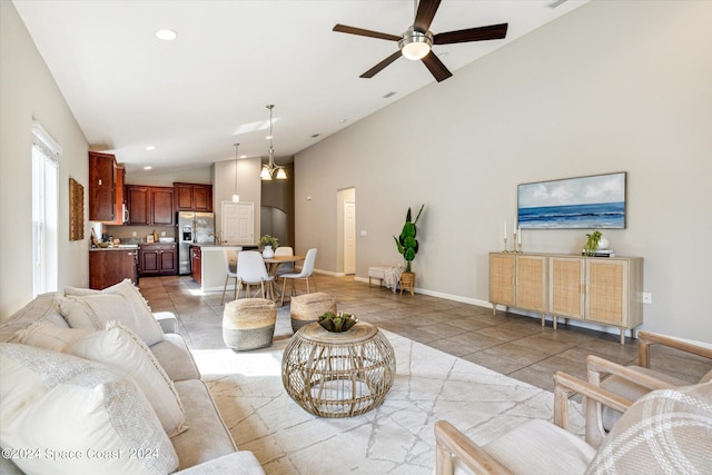 living room featuring tile patterned floors, ceiling fan, and high vaulted ceiling