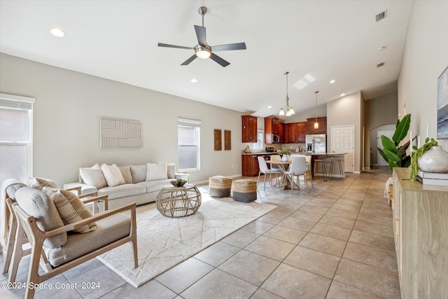 living room featuring ceiling fan, light tile patterned floors, and high vaulted ceiling