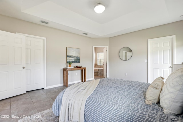 bedroom with ensuite bath, a closet, and light tile patterned flooring