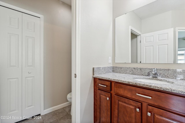 bathroom featuring tile patterned floors, vanity, and toilet