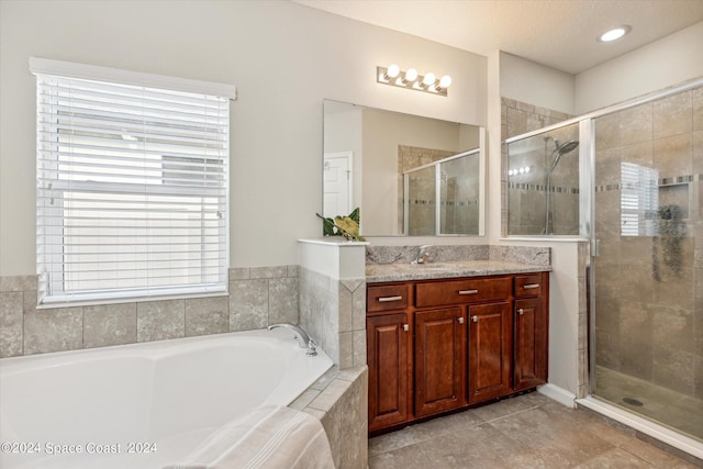 bathroom featuring tile patterned flooring, vanity, and independent shower and bath