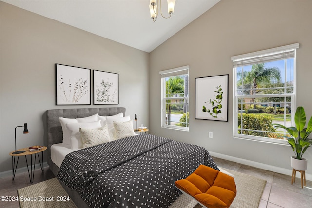 bedroom with light tile patterned floors, high vaulted ceiling, and a chandelier