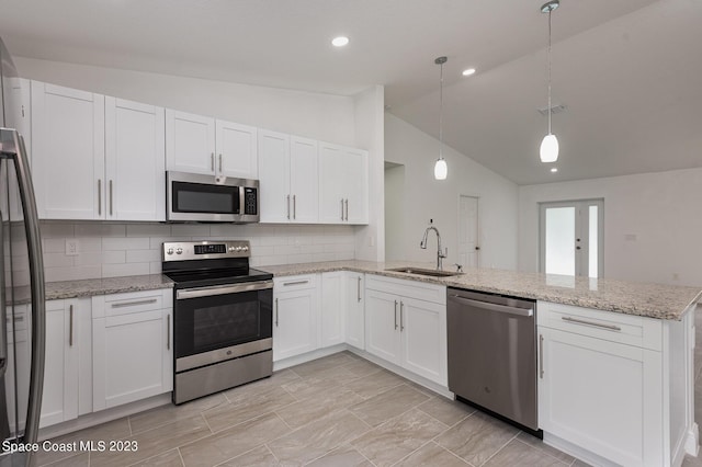 kitchen featuring white cabinetry, a sink, a peninsula, and appliances with stainless steel finishes