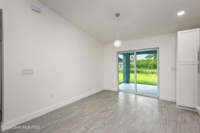 spare room featuring baseboards and recessed lighting