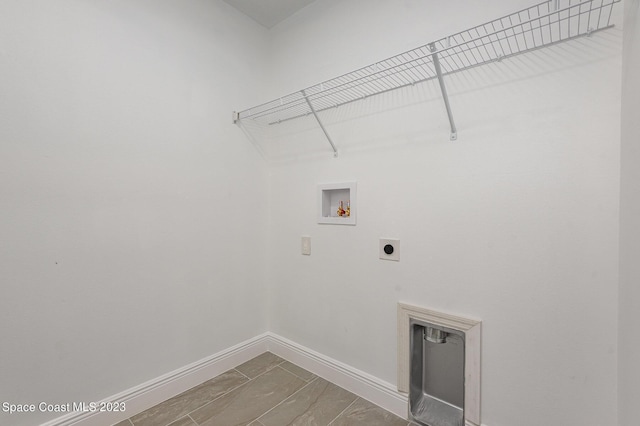 clothes washing area with baseboards, hookup for an electric dryer, laundry area, and hookup for a washing machine