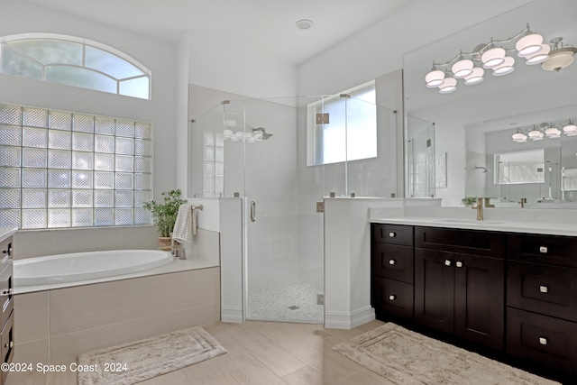 bathroom featuring independent shower and bath and vanity