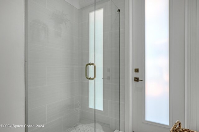 bathroom featuring a shower with door