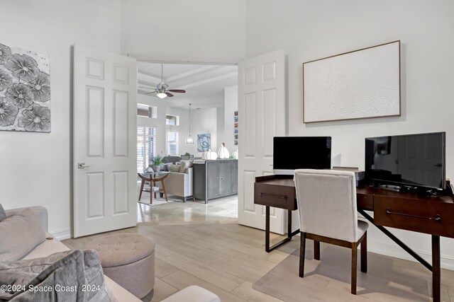 office with ceiling fan and light wood-type flooring