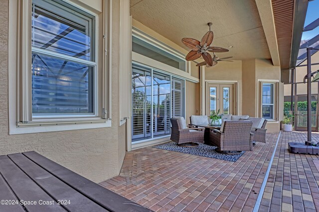 view of patio with an outdoor living space and ceiling fan