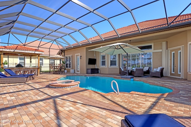 view of swimming pool featuring a patio, a hot tub, and a lanai