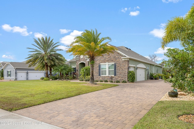 view of front of home with a front yard and a garage