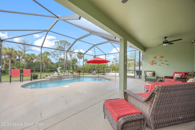 view of swimming pool with a patio, a lanai, ceiling fan, and pool water feature