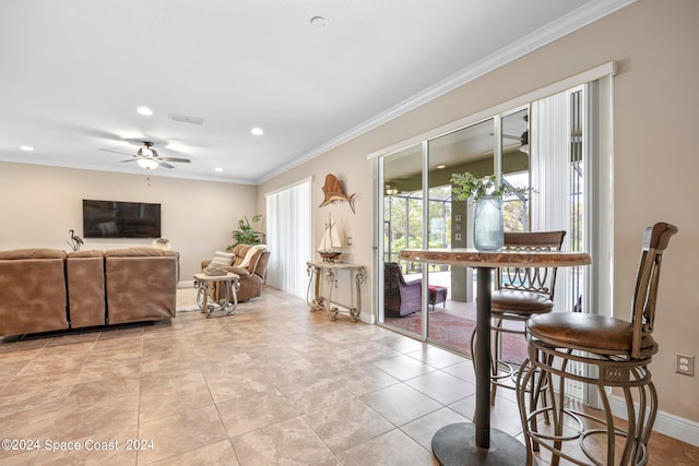 tiled dining space with ornamental molding and ceiling fan