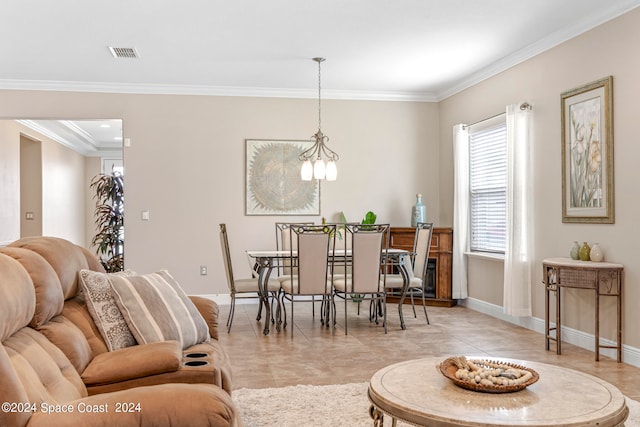 dining area featuring crown molding, light tile patterned floors, and a chandelier