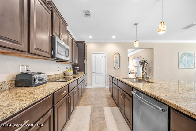 kitchen with appliances with stainless steel finishes, hanging light fixtures, dark brown cabinets, and sink