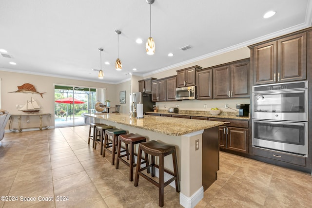 kitchen featuring hanging light fixtures, a breakfast bar, stainless steel appliances, crown molding, and a center island with sink