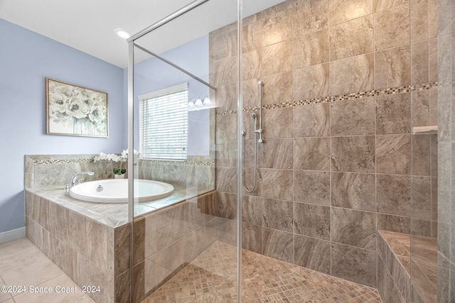 bathroom with independent shower and bath and tile patterned floors