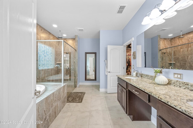 bathroom with tile patterned flooring, vanity, and plus walk in shower