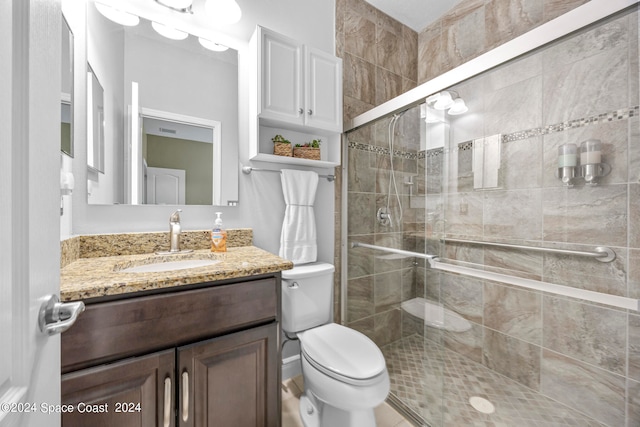 bathroom featuring walk in shower, vanity, and toilet